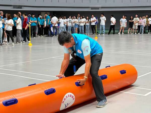 由領隊熊教練示範握把如何抓取之正確姿勢：陸上行舟趣味競賽